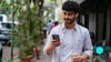 Young man looking at geo-targeted local advertisements on his mobile phone.