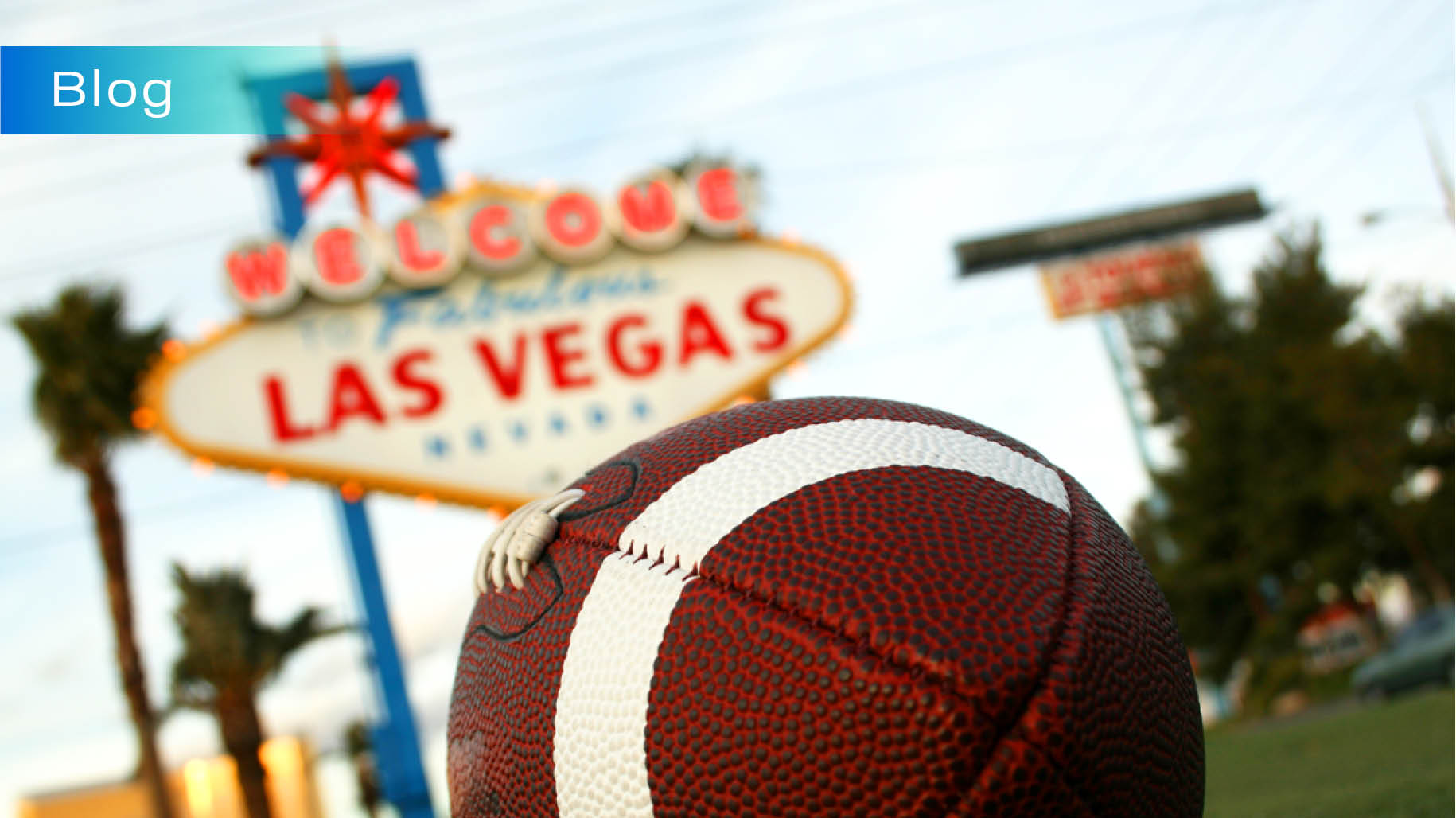 Sports betting illustrated by football by the Las Vegas Sign